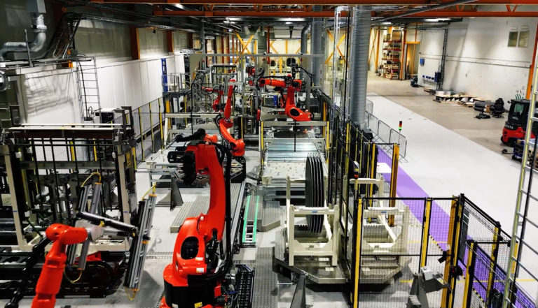 Manufacturing factory with machines in a large room seen from above