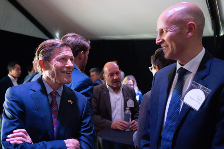 CEO Håkon Volldal and Senator Richard Blumenthal smiling at each other in a crowd